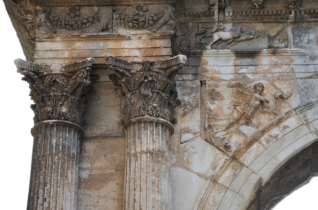 Detail of the Arch of the Sergii. Standing 8 meters high, the arch was constructed in Corinthian style with strong Hellenistic influences. It is richly adorned with relief decorations of grapevines while its centre depicts a scene of an eagle fighting a snake. Two winged victories stand between the inner half columns. 