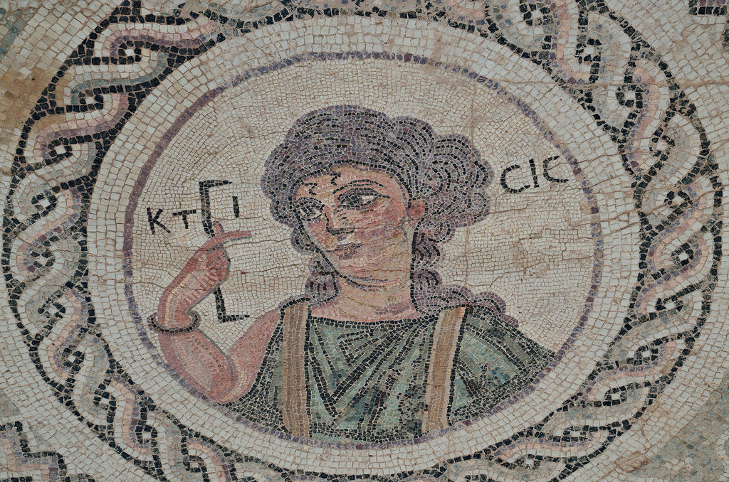 Byzantine mosaic emblema in the House of Eustolios depicting a young woman in a medallion holding a measuring instrument equating of a Roman foot, the Greek inscription identifies her as Ktisis, the personification of Foundation/Donation/Creation, Kourion