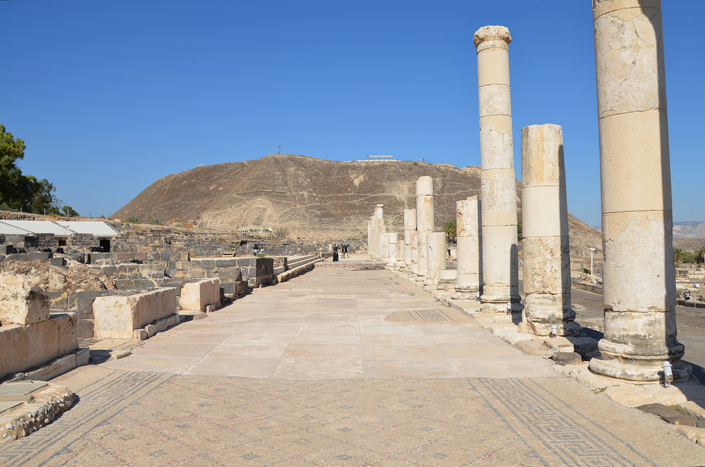 Colonnaded portico along Palladius street paved with intricate mosaics and lined with marble-faced shops.