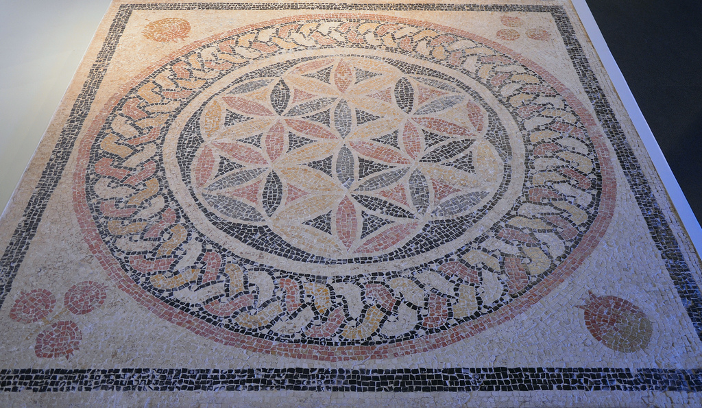 Mosaic floor from Herod's Palace at Herodium with a rosette at its centre and palmettes and pomegranates in the corners. Israel Museum, Jerusalem.