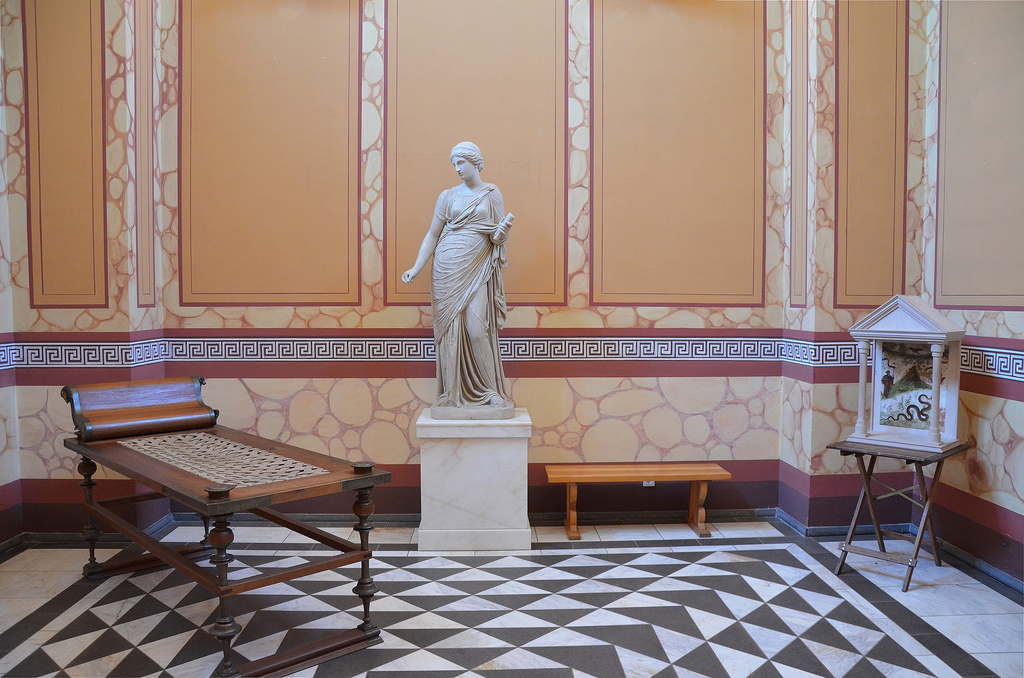 The reconstructed lararium, the sacred place of the house, and a statue of Clio, the muse of history and and a reconstructed lararium, a shrine to the guardian spirits of the Roman household (Lar Familiaris).
