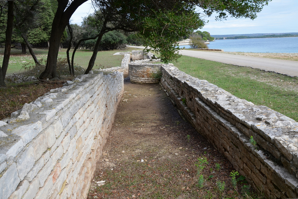 The ruins of one of the monumental porticoes facing the bay.