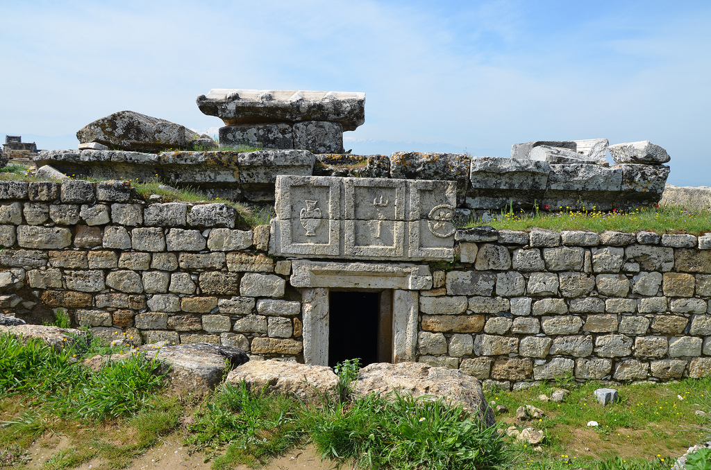 Northern acropolis, Tomb No. 166 (Tomb of the Gladiators). The tomb takes its name from from the travertine slab above the entrance bearing images linked to gladiatorial combat: an amphora for the oil offered as prize to the victor, a trident for combat, a circular shield.