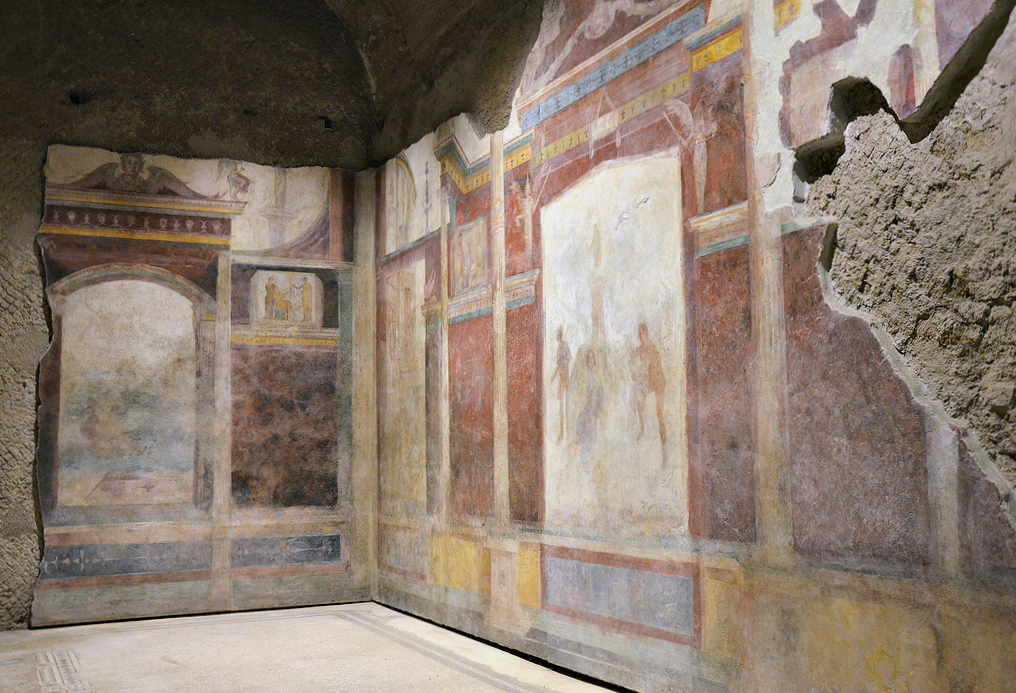 The tablinum with the mythological scenes in the center of both walls. The mythological scene on the right-hand wall of the tablinum is still partly visible.