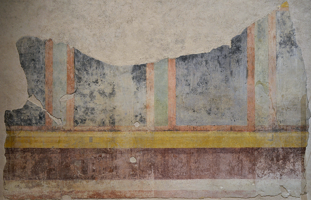 Wall painting fragment alternating wide black and narrow green panels framed in red and bordered above and below in yellow bands.